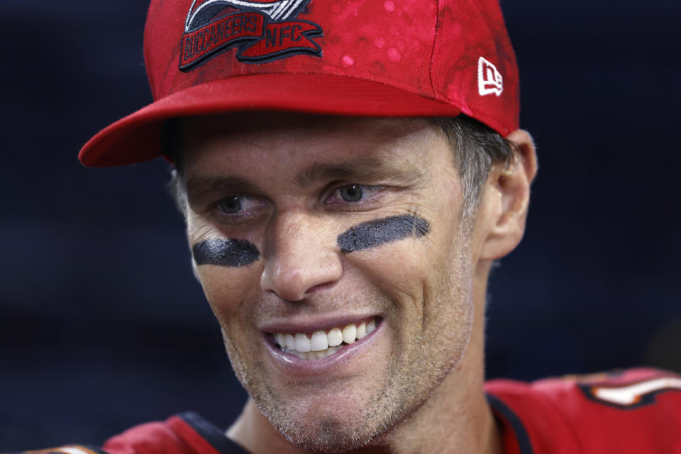 FILE - Tampa Bay Buccaneers quarterback Tom Brady (12) speaks with the media after defeating the Dallas Cowboys 19-3 in an NFL football game in Arlington, Texas, Sunday, Sept. 11, 2022. In some Tampa Bay area schools, students use foam rollers and vibrating spheres to massage their muscles as they work toward goals for strength and flexibility. It's all part of a new physical education curriculum from Brady, whose vision for healthy living is fueling a fitness empire. (AP Photo/Ron Jenkins, File)