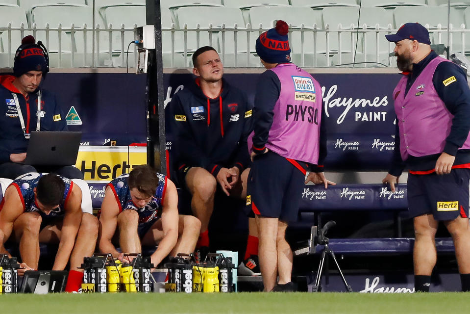 MELBOURNE, AUSTRALIA - MAY 28: Steven May of the Demons sits on the bench after being subbed out of the game after failing a concussion test during the 2022 AFL Round 11 match between the Narrm Demons and the Fremantle Dockers at the Melbourne Cricket Ground on May 28, 2022 in Melbourne, Australia. (Photo by Dylan Burns/AFL Photos via Getty Images)