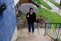 In this April 29, 2020 photo, Julie Hitchcock stands outside her Milwaukee home. Hitchcock, 49, said she worries about getting sick or unknowingly infecting someone else, anxiety that's heightened because she was on a ventilator for two weeks last fall after developing pneumonia. As the coronavirus pandemic upends lives across the nation, a new poll conducted by NORC at the University of Chicago for the Data Foundation found that most Americans reported feeling nervous, depressed, lonely or hopeless in the last week. (AP Photo/Carrie Antlfinger)