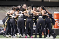 Ottawa University women's flag football team cheers before an NAIA flag football game against Midland University in Ottawa, Kan., Friday, March 26, 2021. The National Association of Intercollegiate Athletics introduced women's flag football as an emerging sport this spring. (AP Photo/Orlin Wagner)