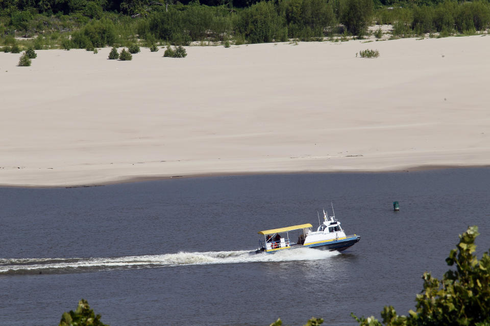 A small boat passes along the Louisiana side of the Mississippi River at Vicksburg, Miss., Thursday, July 26. 2012. in a switch of extremes, the river has dropped to very low levels this summer unlike last year when the river was flooding much of the Delta due to record high levels. The drop in water level now exposes the river bottom, forcing river traffic to a trickle as barges are forced to lessen their loads to keep from getting stuck on sandbars. (AP Photo/Rogelio V. Solis)