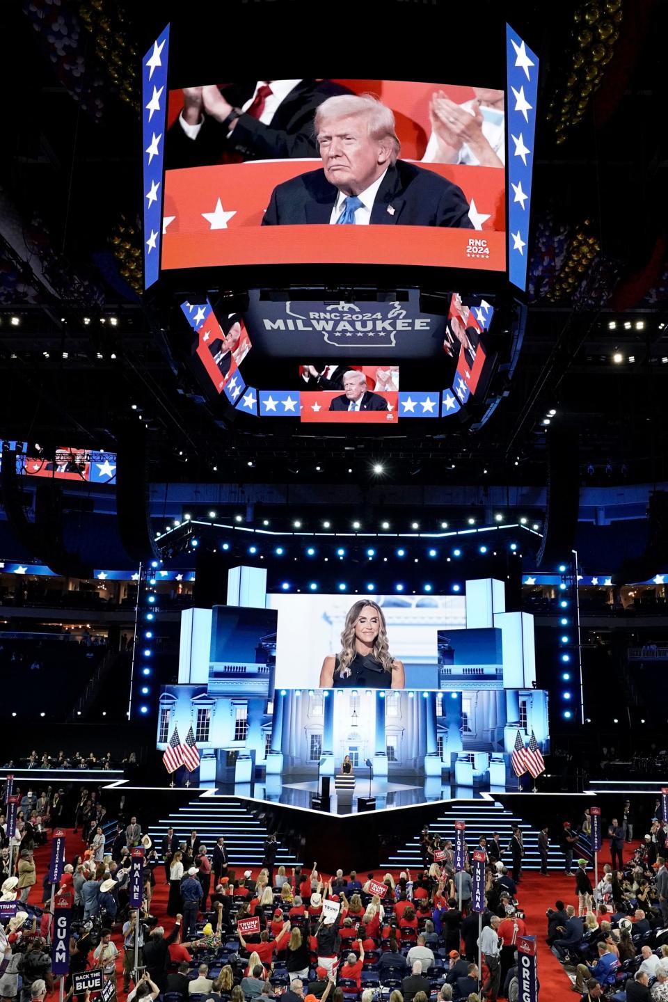 Jul 16, 2024; Milwaukee, WI, USA; Lara Trump delivers remarks as former President Donald Trump listens during the second day of the Republican National Convention at the Fiserv Forum.