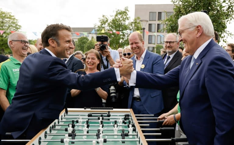 French President Emmanuel Macron (L) and German President Frank-Walter Steinmeier (R) shake hands after playing a table football match during their visit of the Festival of Democracy (Demokratiefest) in Berlin, Germany on May 26, 2024. The French president pays a three-day state visit to Germany until May 28. The festival celebrates the 75th anniversary of Germany's Basic Law. (Ludovic MARIN)