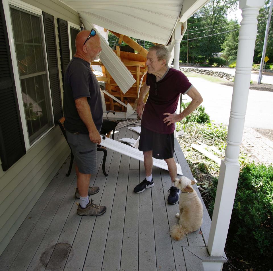 Mark Butler, left, talks with his father-in-law Bill Pedersen on Monday, July 31, 2023, about the small tornado that touched down Saturday, Damaging Butler's Easton home, where they live in.