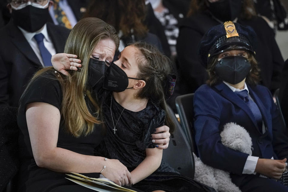 Abigail Evans, 7, Logan Evans, 9, the children of the late U.S. Capitol Police officer William "Billy" Evans, sit with their mother Shannon Terranova, left, during a memorial service as Evans lies in honor in the Rotunda at the U.S. Capitol, Tuesday, April 13, 2021 in Washington. (Drew Angerer/Pool via AP)