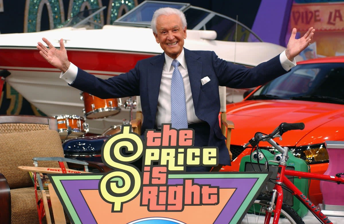 Game show host Bob Barker poses amongst a sea of prizes at the 