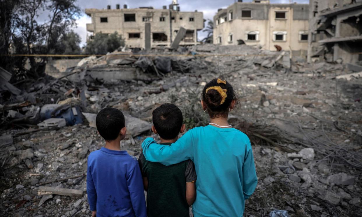<span>Children stand amid the rubble of a building hit by an Israeli air strike in the centre of the Gaza Strip.</span><span>Photograph: AFP/Getty Images</span>