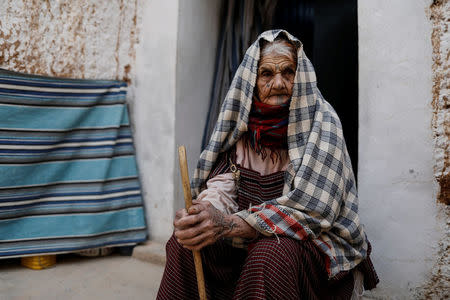 Mariem, 89, sits outside of her troglodyte house on the outskirts of Matmata, Tunisia, February 4, 2018. REUTERS/Zohra Bensemra