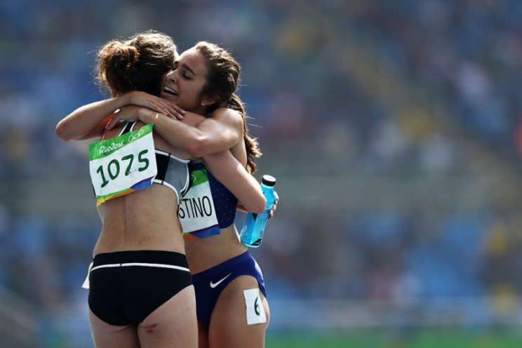 Olympic runners embrace after a collision. (Patrick Smith/Getty Images)