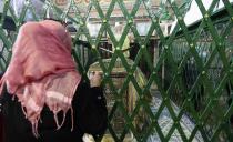 A woman prays near the grave of Sidi Sahibi at the mausoleum ahead of Eid-e-Milad-ul-Nabi, the birthday of Prophet Mohammad, in Kairouan January 13, 2014. REUTERS/Stringer (TUNISIA - Tags: RELIGION SOCIETY ANNIVERSARY)