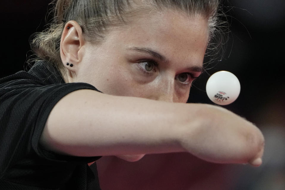 FILE - In this Aug. 25, 2021, file photo, Natalia Partyka of Poland serves against Nozomi Takeuchi of Japan in Class 10, Group A of women's table tennis competition at the Tokyo 2020 Paralympic Games in Tokyo, Japan. There are 4,403 Paralympic athletes competing in Tokyo, each with unique differences that have to be classified. Lines have to be draw, in the quest for fairness, to group similar impairments, or impairments that yield similar results.(AP Photo/Eugene Hoshiko, File)