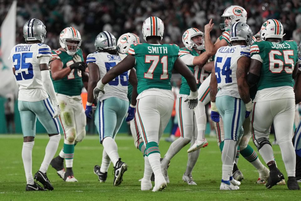 Miami Dolphins punter Jake Bailey (16) celebrates with place kicker Jason Sanders, right, as he gets lifted up by teammates following a game-winning field goal against the Dallas Cowboys at Hard Rock Stadium in Miami Gardens, Dec. 24, 2023.