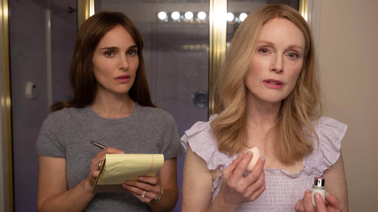  Natalie Portman and Julianne Moore stand next to each other in May December. 