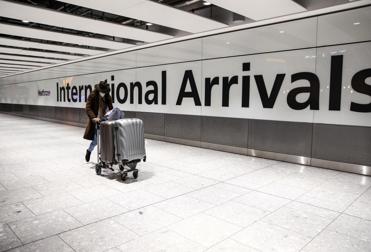 Passenger wearing a face mask arrives at the Heathrow international arrival hall. (Photo by May James / SOPA Images/Sipa USA)