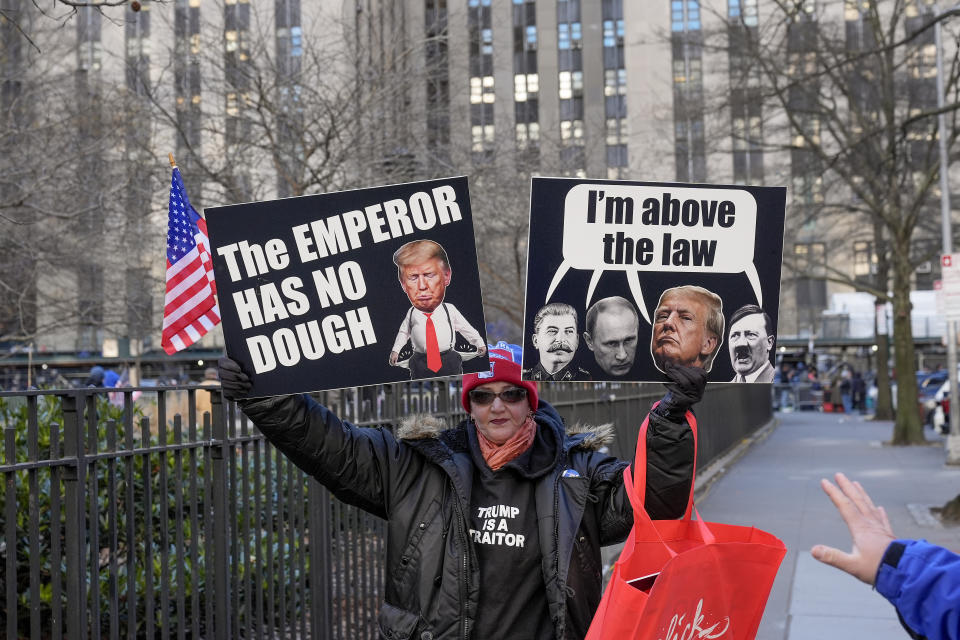 A protestors demonstrates outside Manhattan criminal court while awaiting the arrival of former President Donald Trump, Monday, March 25, 2024, in New York. A judge will weigh on Monday when the former president will go on trial. (AP Photo/Seth Wenig)