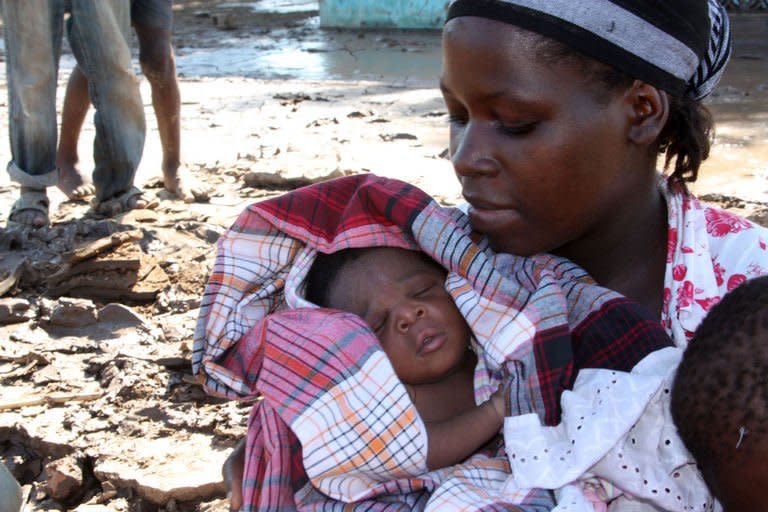 Rofino, a baby born on the roof of his mother's house while floodwaters were raging past, is held by his mother in Guija, southern Mozambique on January 27, 2013. Intense flooding in Mozambique has displaced at least 150,000 people, the United Nations said Monday, with the figure expected to rise further as fresh rains spread flooding northward