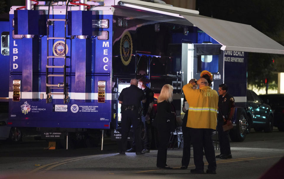 Police gather outside a mobile command post as they investigate the scene of a shooting in Long Beach on Wednesday, Oct. 30, 2019. Authorities say three people were fatally shot and nine others injured at a home in Long Beach, California.(Scott Varley/The Orange County Register via AP)/The Orange County Register via AP)