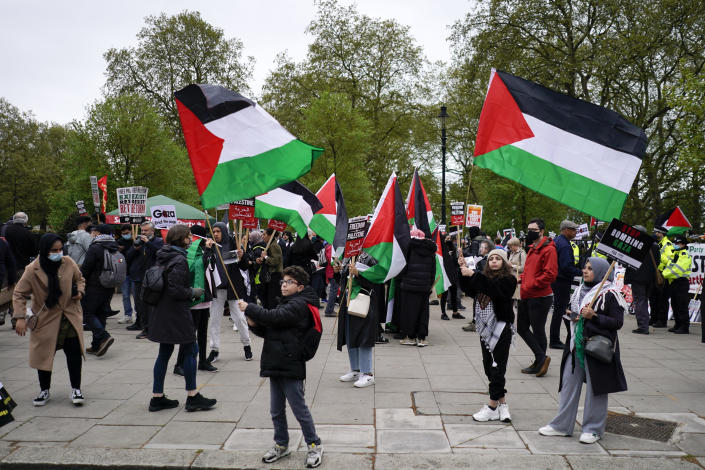 People hold placards and Palestinian flags as they march in solidarity with the Palestinian people amid the ongoing conflict with Israel, during a demonstration in London, Saturday, May 15, 2021.(AP Photo/Alberto Pezzali)