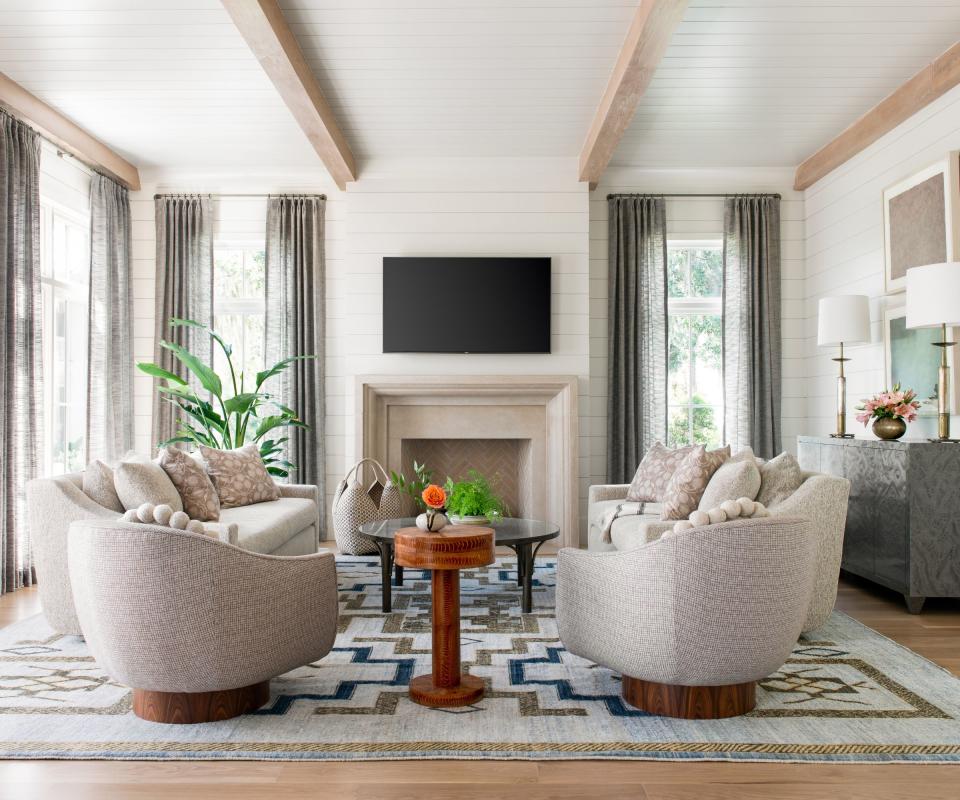 Living room with chairs in front of a fireplace