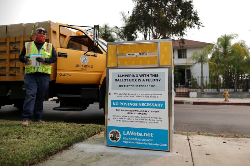 FILE PHOTO: StreetsLA workers install one of 123 Vote by Mail Drop Boxes outside a public library, amid the global outbreak of the coronavirus disease (COVID-19), in Los Angeles