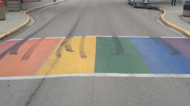 Saskatchewan's oldest rainbow crosswalk was recently damaged by a vehicle burning out tires on it.  (Joey Donnelly - image credit)
