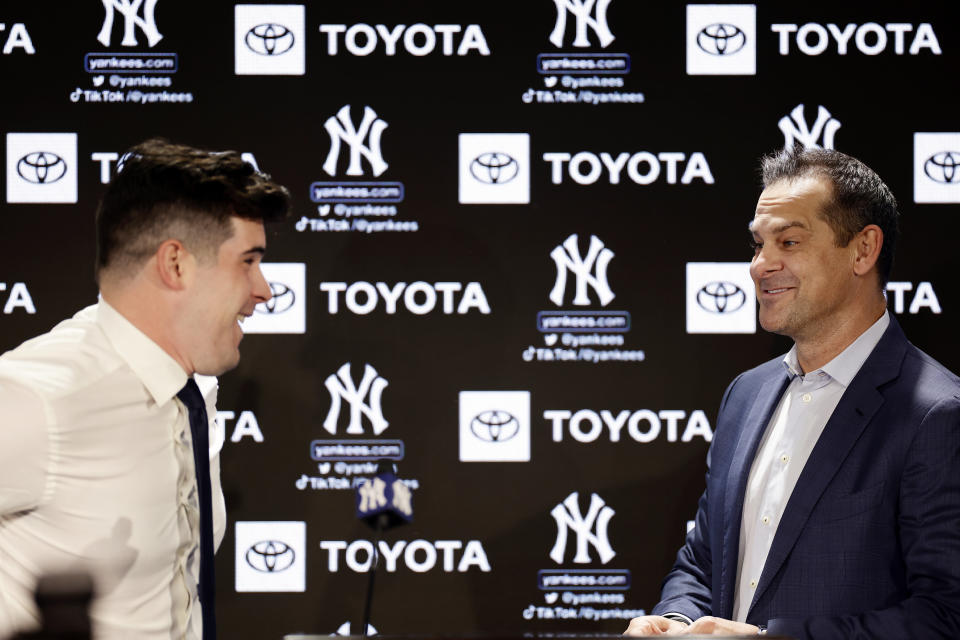 New York Yankees' Carlos Rodon, left, talks with manager Aaron Boone during his introductory baseball news conference at Yankee Stadium, Thursday, Dec. 22, 2022, in New York. (AP Photo/Adam Hunger)