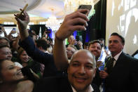 Brazil's right wing ex-president Jair Bolsonaro, right, is greeted by enthusiastic supporters as he leaves after speaking an event hosted by conservative group Turning Point USA, at Trump National Doral Miami, Friday, Feb. 3, 2023, in Doral, Fla. (AP Photo/Rebecca Blackwell)