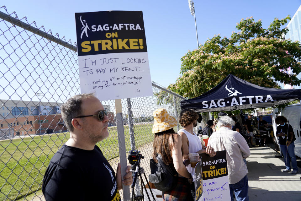 SAG-AFTRA member Chris Paseka takes part in a rally by striking writers and actors outside Netflix studio in Los Angeles on Friday, July 14, 2023. This marks the first day actors formally joined the picket lines, more than two months after screenwriters began striking in their bid to get better pay and working conditions. (AP Photo/Chris Pizzello)