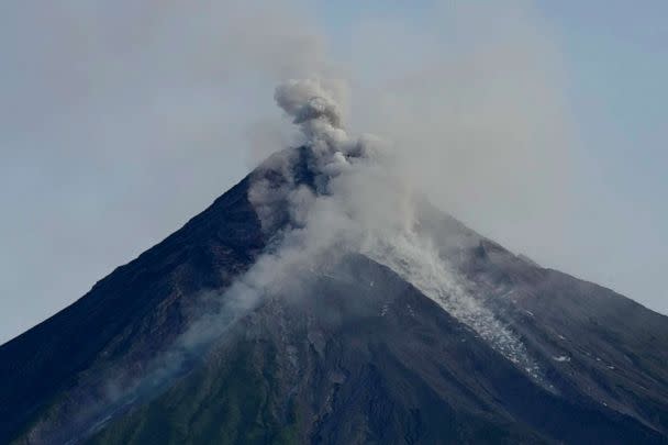 PHOTO: Mayon volcano spews ash and lava as seen from Daraga town, Albay province, northeastern Philippines, June 14, 2023. (Aaron Favila/AP)