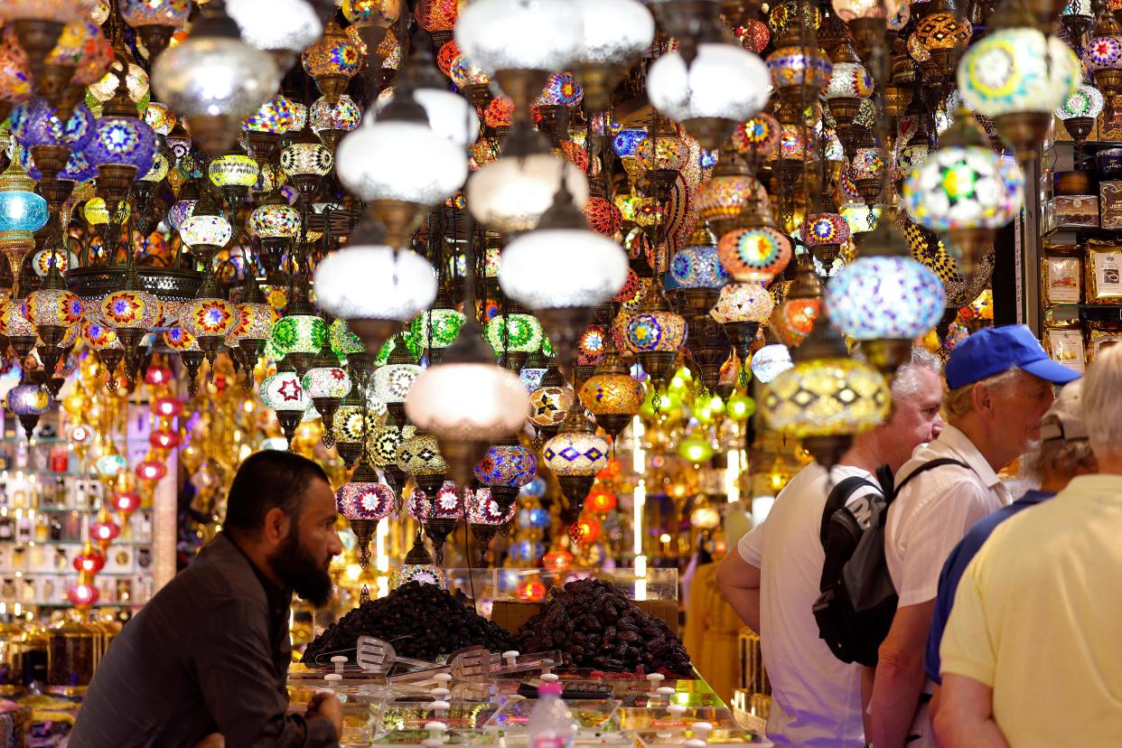 People stand at a store selling decorations at the Souq Ramadan in Dubai on March 20, 2023 ahead of the Muslim holy fasting month of Ramadan.