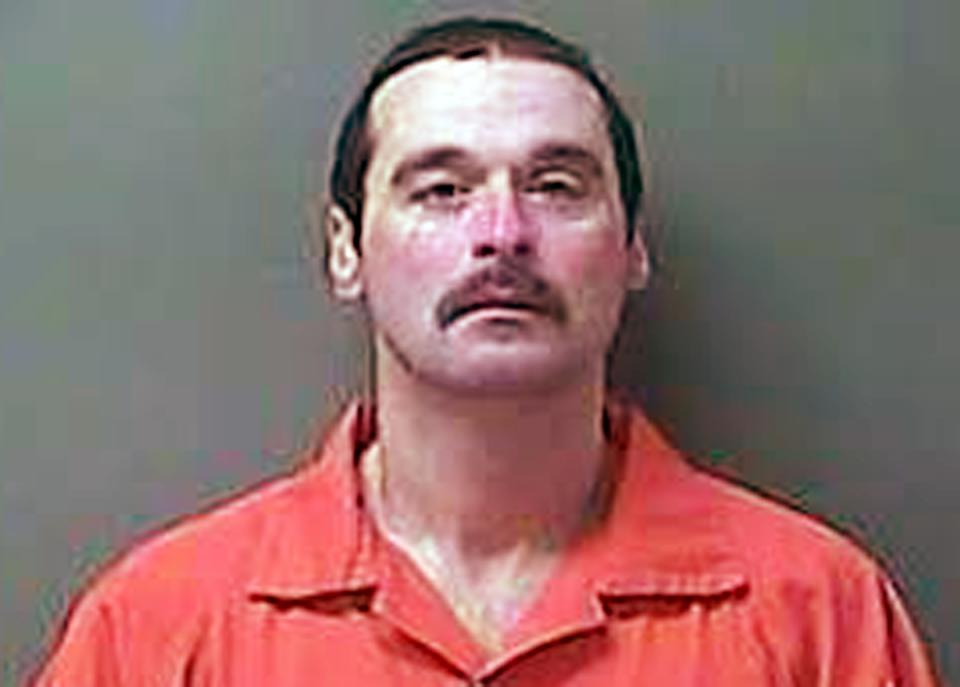 In this photo provided by the LaPorte County, Ind., Sheriff's Department is Michael Elliot who was arrested Monday, Feb. 3, 2014 in LaPorte County, Ind., more than 150 miles from the Ionia, Mich., Correctional Facility he escaped from on Sunday. The convicted killer was captured in a stolen car Monday in Indiana and has been charged with charged with escape, kidnapping and carjacking, according to authorities. (AP Photo/LaPorte County Sheriff's Department)