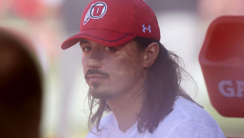 Utah QB Cam Rising watches from the sideline as Utah warms up for a game against the USC Trojans at the Los Angeles Memorial Coliseum on Saturday, Oct. 21, 2023.