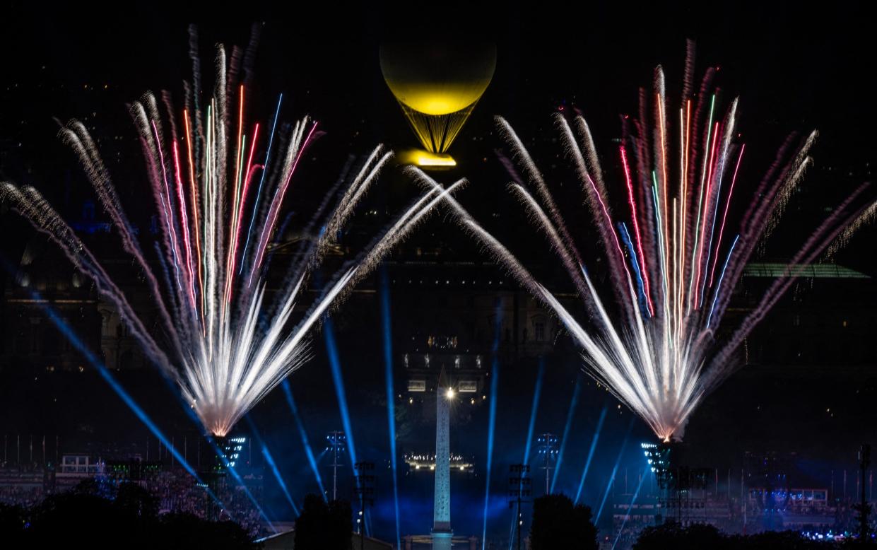 The Paralympic flame above the Luxor Obelisk and the Louvre museum