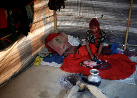 Rehana Begum, 25, sits near her one-day-old unnamed daughter inside their shelter at Kutupalang unregistered refugee camp in Cox’s Bazar, Bangladesh, February 10, 2017. REUTERS/Mohammad Ponir Hossain