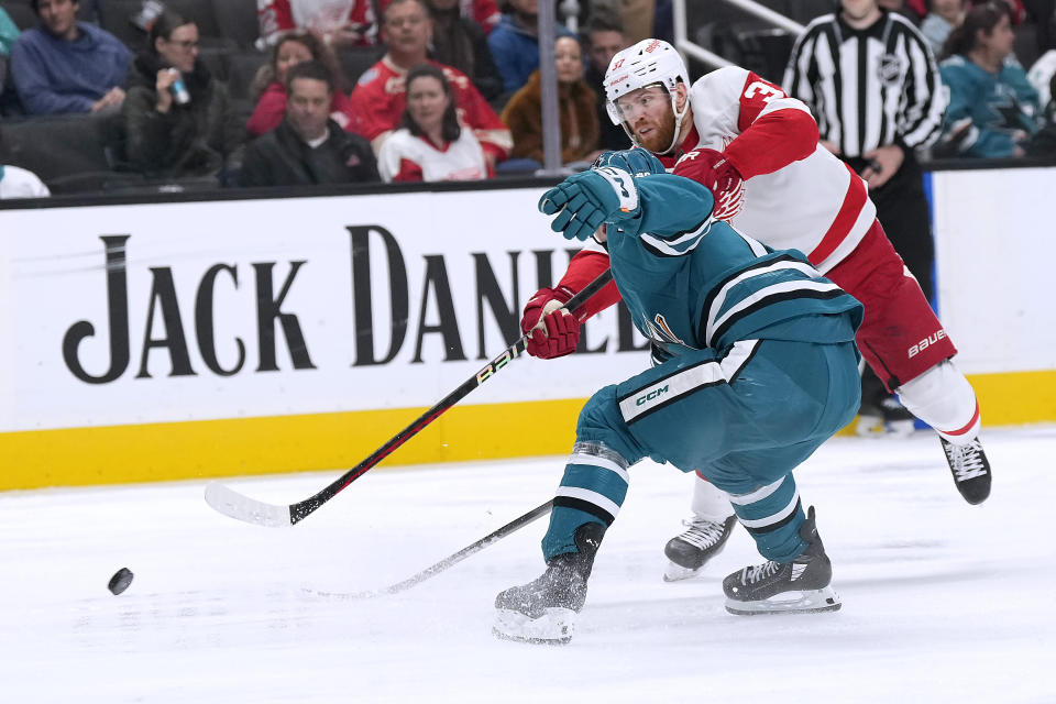 Detroit Red Wings left wing J.T. Compher (37) scores a goal past San Jose Sharks left wing William Eklund during the second period of an NHL hockey game Tuesday, Jan. 2, 2024, in San Jose, Calif. (AP Photo/Tony Avelar)