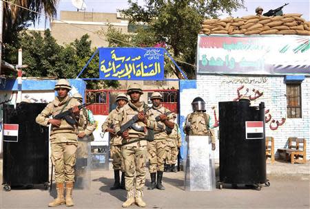 Egyptian soldiers stand guard in the courtyard of a school that will be used as a polling station in Port Said January 13, 2014. REUTERS/Al Youm Al Saabi Newspaper