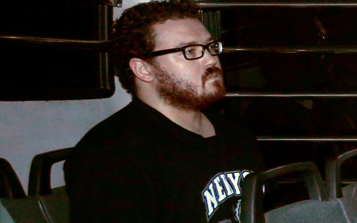 Rurik Jutting in the back row of a prison bus as he arrives at the Eastern Law Courts in Hong Kong November 24, 2014 - REUTERS