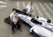 The newly announced Williams Martini Racing driver for the 2017 season Lance Stroll (L) poses for photographers with team-mate Valteri Bottas beside this year's Formula 1 car at their base in Wantage, Britain November 3, 2016. REUTERS/Eddie Keogh