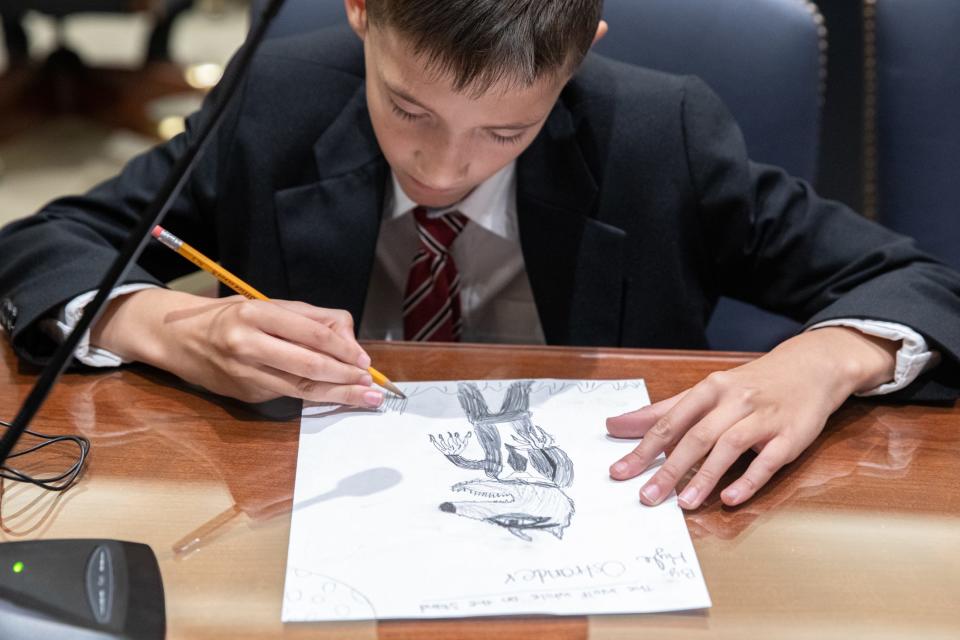 Flour Bluff student Kyle Ostrander, portraying a courtroom sketch artist, draws defendant, The Big Bad Wolf, during a mock trial at the Federal Courthouse on Thursday, Nov. 16, 2023, in Corpus Christi, Texas.