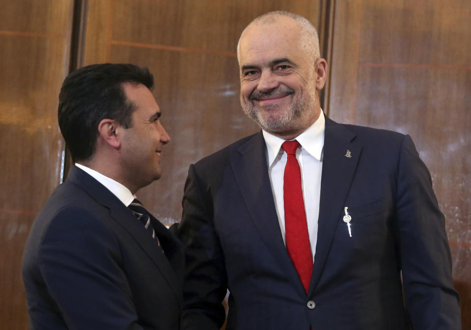 North Macedonia's Prime Minister Zoran Zaev, left, and his Albanian counterpart smile during their meeting in Tirana, Wednesday, March 13, 2019. The two leaders say they believe that the European Union will decide in June to open membership talks with them. (AP Photo)