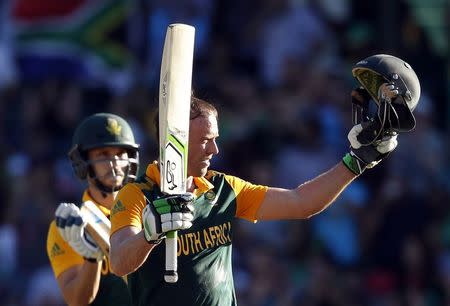 South Africa's captain AB de Villiers (R) is applauded by team mate Farhaan Behardien as he celebrates reaching his century during the Cricket World Cup match against the West Indies at the Sydney Cricket Ground (SCG) February 27, 2015. REUTERS/Jason Reed