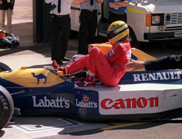 Ayrton Senna hitches a ride on Nigel Mansell’s Williams Renualt after he ran out of fuel on the last lap of the British Grand Prix at Silverstone