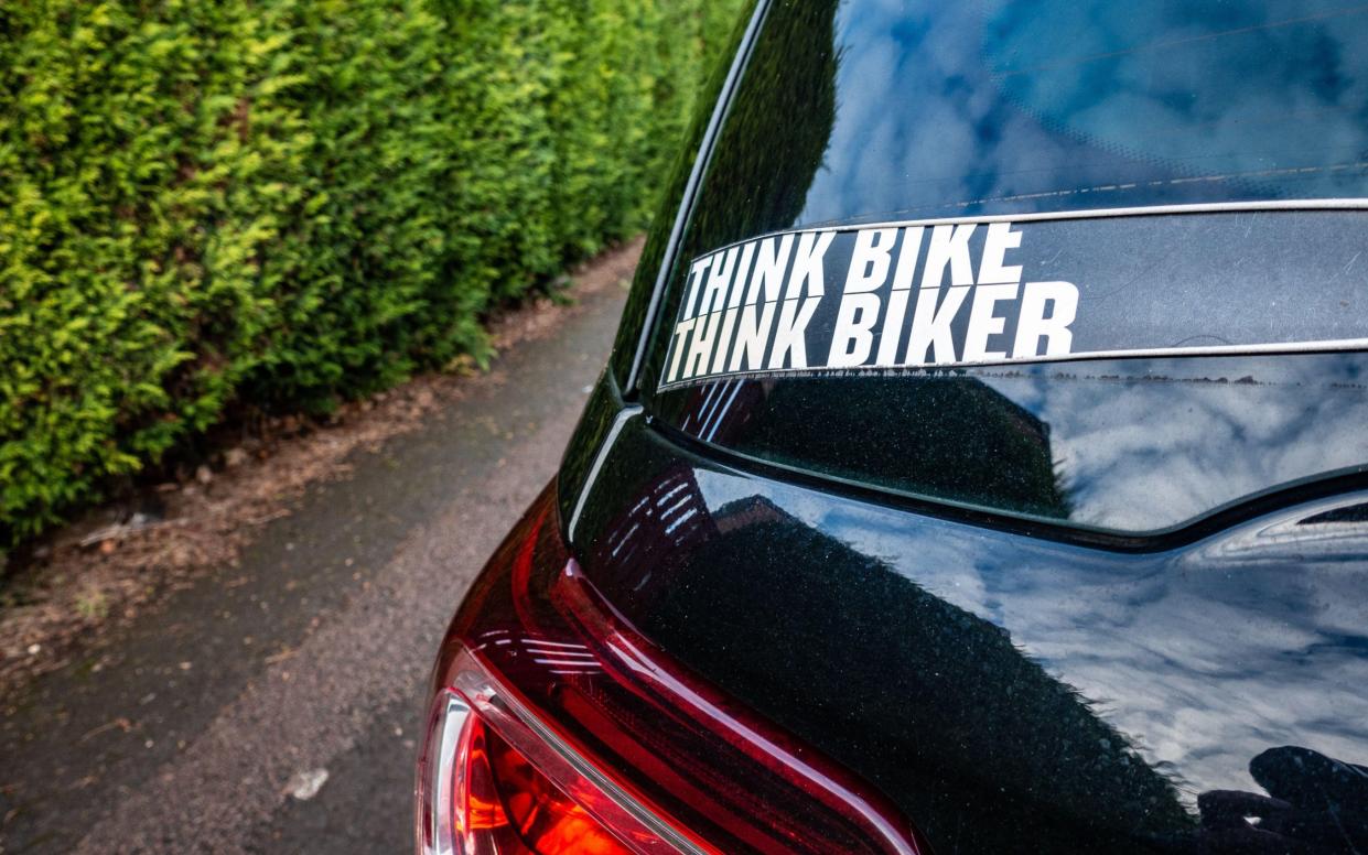 A larger Think Bike sticker scene on the back of a car