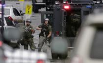 Law enforcement officers respond to the scene of a shooting at the Washington Navy Yard in Washington, September 16, 2013. Several people were killed and others injured when at least one gunman opened fire at the U.S. Navy Yard in Washington D.C. on Monday, authorities said. One Navy official said that four people had died and eight others were injured, but other officials suggested caution over those numbers saying the situation was in flux. (REUTERS/Jason Reed)