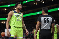 Minnesota Timberwolves center Karl-Anthony Towns (32) talks to referee Bill Kennedy during the first half of the team's NBA basketball game against the Atlanta Hawks on Wednesday, Jan. 19, 2022, in Atlanta. (AP Photo/Hakim Wright Sr.)