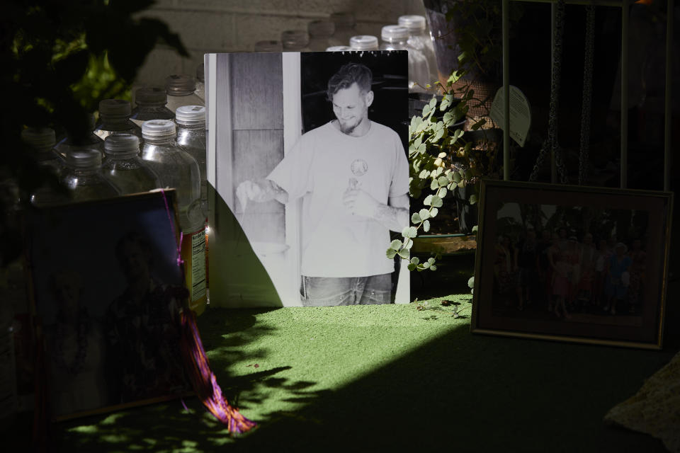 A photo of Brian Spaulding sits on the porch of his parent's home Portland, Ore., Wednesday, July 20, 2022. He was killed in 2017 and the case remains open. The detective assigned to investigate the death of Spaulding, a chiropractic assistant who didn’t do drugs, wasn’t in a gang and lived close to the house where he was born, left in 2020 in a wave of retirements and the detective assigned to it now is swamped with fresh cases after Portland’s homicide rate surged 207% since 2019. (AP Photo/Craig Mitchelldyer)