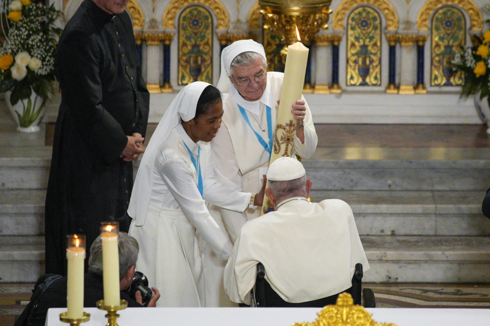 Pope Francis blesses a candle during a Marian prayer with the diocesan clergy, at the Notre Dame de la Garde Basilica, in Marseille, France, Friday, Sept. 22, 2023. Francis, during a two-day visit, will join Catholic bishops from the Mediterranean region on discussions that will largely focus on migration. (AP Photo/Daniel Cole)