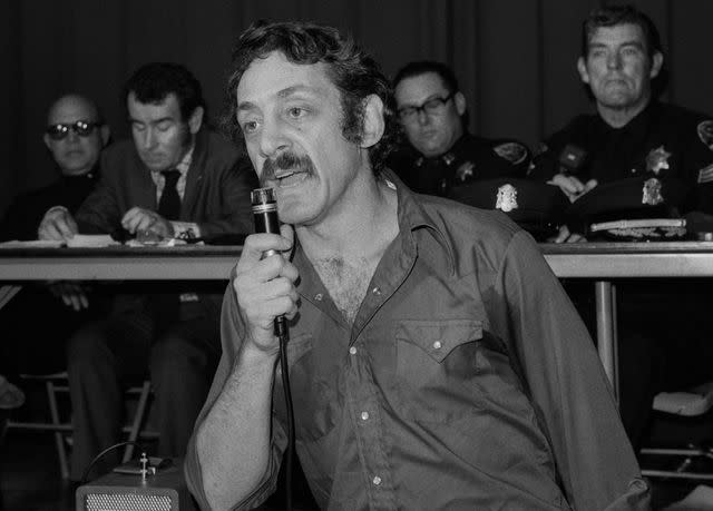 <p>Janet Fries/Getty</p> Harvey Milk speaks during a Police Community Relations meeting in San Francisco, California in September 1974.