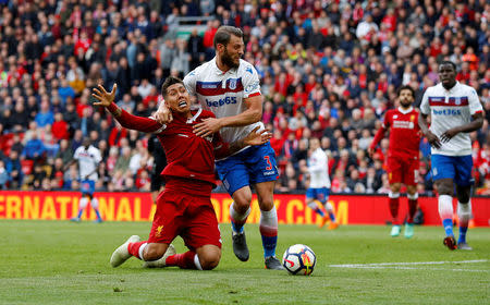 Soccer Football - Premier League - Liverpool v Stoke City - Anfield, Liverpool, Britain - April 28, 2018 Liverpool's Roberto Firmino in action with Stoke City's Erik Pieters REUTERS/Phil Noble