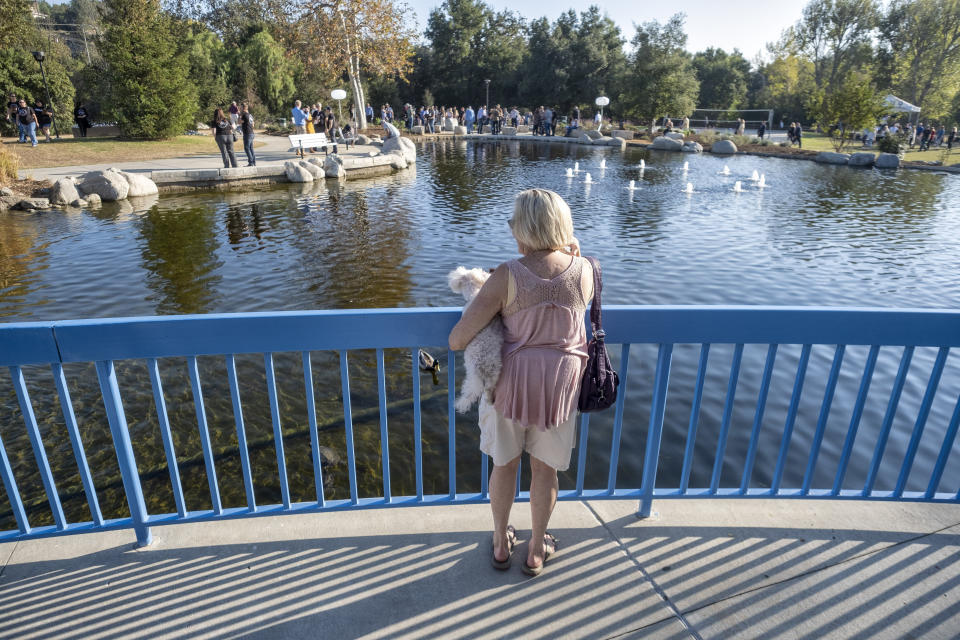 A woman looks at the Borderline Healing Garden at Conejo Creek Park in Thousand Oaks, Calif., Thursday, Nov. 7, 2019. The dedication marked the anniversary of a fatal mass shooting at a country-western bar a year earlier. (Hans Gutknecht/The Orange County Register via AP)